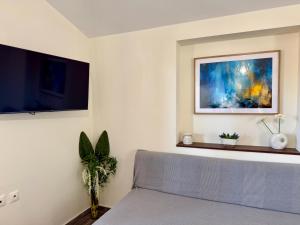 a living room with a couch and a tv at Sonia in Leptokarya