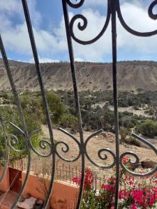 a view of the mountains through a gate at calm appart in Agadir