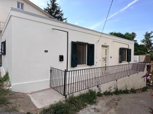 a white building with a gate and a fence at La Terrazza in Ortona