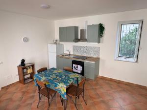 a kitchen with a table and a kitchen with a table and chairs at La Terrazza in Ortona +26 photos