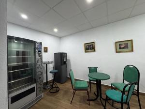 a waiting room with green chairs and a refrigerator at El Palmar in Tobarra +103 photos