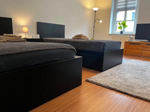 a bedroom with two beds and a flat screen tv at Stylische Flat1 mit französischem Balkon1 all-in 5G in Gera