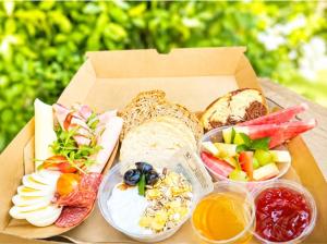 a box of food with different types of bread and fruits at Estia Luxury Suites & Spa in Platamonas