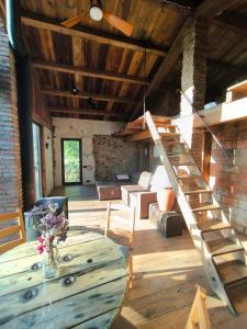 a living room with a table and a wooden ceiling at Can Cirili Rustic Romantic apartment for couples or family events in Bordils +20 photos