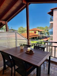 a wooden table with two candles on a balcony at Sonia in Leptokarya
