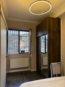 a room with two windows and a chandelier at Didveli Mountain Apartment in Bakuriani