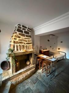 a living room with a stone fireplace and a table at Dukes place in Mestá