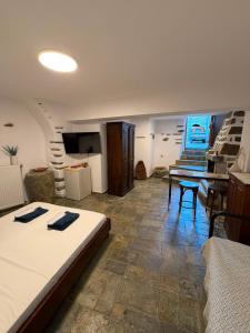 a bedroom with a bed and a table and a staircase at Dukes place in Mestá