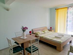 a bedroom with a bed and a table and chairs at Apartments M&Z in Budva
