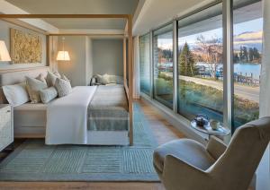 a bedroom with a bed and a large window at ROKI Collection in Queenstown +14 photos