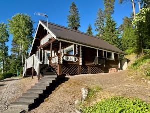 a log cabin with stairs leading up to it at Kesäpesä in Artjärvi