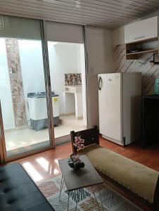 a living room with a refrigerator and a table at Apartamento Victoria B in Ríohacha
