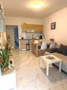 a living room with a couch and a table at Sun house in Krk