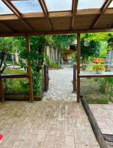 an outdoor patio with a wooden pergola at Le Case Gialle Resort in Gualdo Cattaneo +62 photos