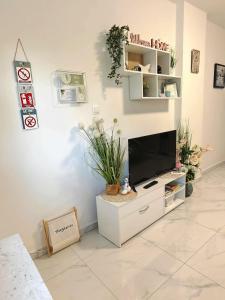 a living room with a tv on a white cabinet at Sun house in Krk