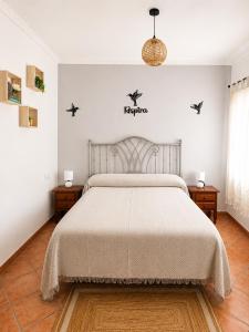 a bedroom with a bed with birds on the wall at Los Meri in Grazalema +17 photos
