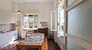 a kitchen with a table in the middle of a room at Casa Picarol Monferrato in Bergamasco