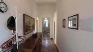 a living room with a clock on a wall at Casa Picarol Monferrato in Bergamasco