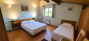 a bedroom with two beds and a window at maison de vacances in Tourrettes +3 photos