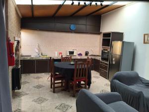 a kitchen with a table and chairs and a refrigerator at Yahweh in Río Grande