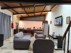 a room with chairs and a table and a projection screen at Yahweh in Río Grande