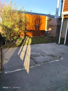 a shadow of a fence on a driveway at Yahweh in Río Grande
