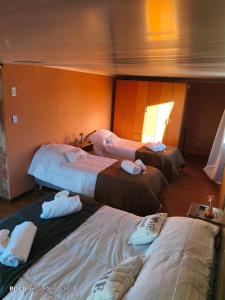 a hotel room with three beds in a room at Yahweh in Río Grande