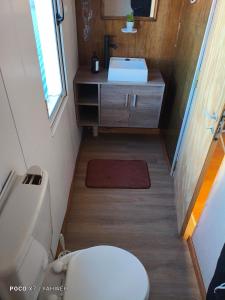 a small bathroom with a toilet and a sink at Yahweh in Río Grande +18 photos