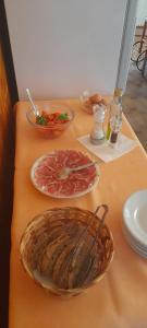 a table with plates and bowls of food on it at Albergo Ristorante Il Torrione in Auditore +18 photos
