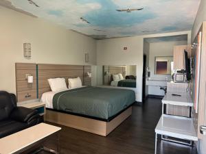 a hotel room with a bed and a couch at Crescent Inn in Wilmington