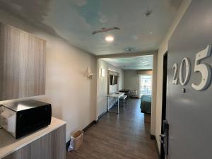 a hallway with a room with a bed and a television at Crescent Inn in Wilmington