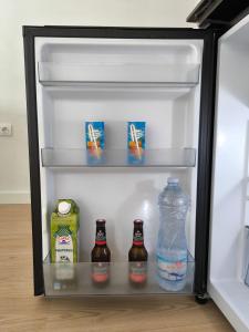 an open refrigerator with drinks and bottles of water at Casa Gaia Centrally located accommodation with spacious rooms in Redondela