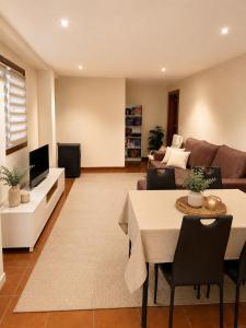 a living room with a couch and a table at Casa con piscina y jacuzzi in Pontevedra