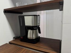 a coffee maker on a shelf in a kitchen at M e M executivo in Ipatinga