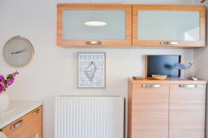 a kitchen with a white radiator and a clock at Angie's Serenity Apartment in Vathí +42 photos