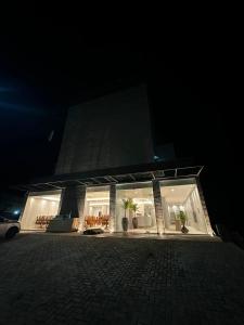 a building at night with lights in the windows at UMARI Reserva Hotel in Marituba