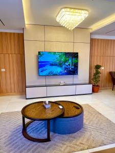 a living room with a coffee table and a tv at ريڨا للأجنحة السكنية Riva suites in Irbid
