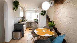 a kitchen and dining room with a table and chairs at Bytča Central Apartment in Bytca