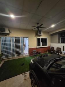 a living room with a ceiling fan and grass at Ctr Ruby homestay in Shah Alam