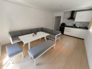 a living room with a couch and a table and chairs at Casa Gaia Centrally located accommodation with spacious rooms in Redondela +7 photos