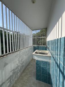 a bathroom with blue tiles and a sink on a balcony at Cartagena Visible Casa de Huéspedes in Cartagena de Indias