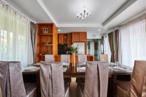 a dining room with a table and chairs at NB Villa Vimana in Bang Rak Beach