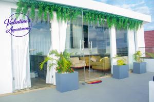 a building with plants in front of a window at Valentinos Appartement Prestige in Agbodrafo