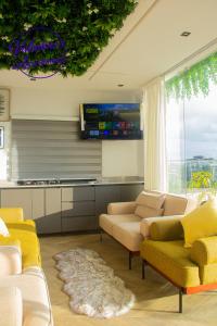 a living room with couches and a flat screen tv at Valentinos Appartement Prestige in Agbodrafo