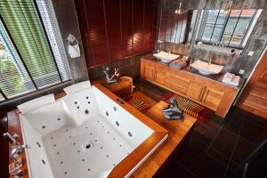 a large bathroom with a tub and two sinks at NB Villa Vimana in Bang Rak Beach +28 photos