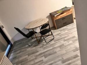 a table and two chairs sitting on a wooden floor at Zimmer heilbronn in Heilbronn