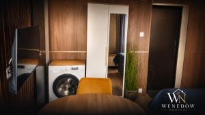 a room with a washing machine and a washer at 205 Wenedow Noclegi in Koszalin