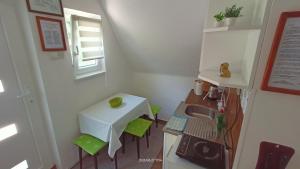 a small kitchen with a sink and a table at Apartman Đurić in Donji Milanovac