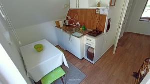 a small kitchen with a table and a sink at Apartman Đurić in Donji Milanovac