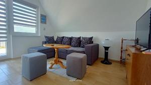 a living room with a couch and a table at Apartman Đurić in Donji Milanovac